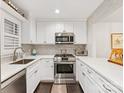 Well-lit kitchen with stainless steel appliances, white countertops and brick backsplash at 2719 Selwyn Ave # 20, Charlotte, NC 28209