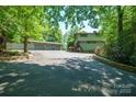 Exterior shot of home and three-car garage with well-maintained landscaping and long driveway at 3165 Laurel Ridge Nw Rd, Hickory, NC 28601