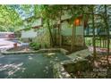 Attractive home exterior with stone accents, landscaped beds and mature trees providing privacy at 3165 Laurel Ridge Nw Rd, Hickory, NC 28601