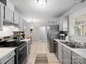 Well-lit kitchen featuring stainless steel appliances, tile backsplash, and ample cabinet space at 500 Colony Acres Dr, Charlotte, NC 28217