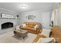 Cozy living room features a brick fireplace, plush seating, and stylish decor at 500 Colony Acres Dr, Charlotte, NC 28217