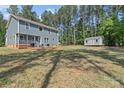 Expansive backyard features a deck with seating and a storage shed at 539 Morrison Farm Rd, Troutman, NC 28166
