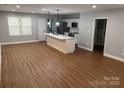 Bright living room with wood floors, neutral walls and a stylish kitchen island at 704 Guinn St, Clover, SC 29710