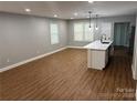 Spacious living room featuring wood floors and a kitchen island with pendant lighting at 704 Guinn St, Clover, SC 29710