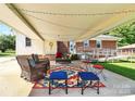 Inviting covered patio area with stylish furniture, creating a perfect outdoor gathering space at 704 Kingman Dr, Charlotte, NC 28217