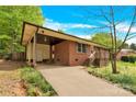 Side view of brick home with a covered side car port and entrance at 735 Wilbrown Cir, Charlotte, NC 28217