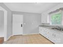 Kitchen featuring tile flooring, white cabinets and stainless steel sink at 735 Wilbrown Cir, Charlotte, NC 28217