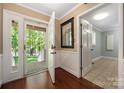 Inviting foyer with hardwood floors, mirror, leading to other rooms, and an open view of the outdoor porch at 7888 Golf Course N Dr, Denver, NC 28037