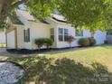Well-maintained home featuring green shutters, lush landscaping, and a freshly cut lawn for curb appeal at 8027 Bristle Ln, Charlotte, NC 28214