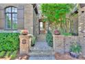Inviting front entrance featuring a stone path, brick pillars and a wooden front door at 809 Verney Ln, Charlotte, NC 28226