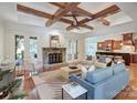 Bright living room with beamed ceilings, a stone fireplace, and hardwood floors at 809 Verney Ln, Charlotte, NC 28226