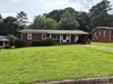 Well-maintained single-story brick house with a covered front porch and a green, spacious yard at 908 Mcgowan Rd, Shelby, NC 28150