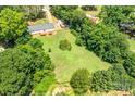 Expansive backyard featuring mature trees and an open lawn, perfect for outdoor activities and enjoying the natural surroundings at 10230 Hagers Rd, Huntersville, NC 28078