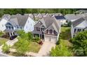 Overhead shot of a well-maintained two-story home with a manicured lawn and a two-car garage in a residential area at 11014 Aspen Ridge Nw Ln, Concord, NC 28027