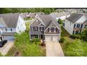 Beautiful aerial view of a two-story home with lush landscaping and a two-car garage in a suburban neighborhood at 11014 Aspen Ridge Nw Ln, Concord, NC 28027