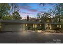 Charming single-Gathering home features an attached two-car garage, a paved driveway, and meticulously manicured landscaping at 115 Forestcliff Ne Ct, Concord, NC 28025
