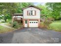 Two-story home featuring attached garage, upper level and a lush green surroundings at 1205 Southwood Dr, Newton, NC 28658