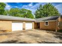 Two-car garage is attached to this brick home, with access from a large concrete driveway at 1491 Cedar Grove Rd, Clover, SC 29710