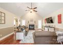 Spacious living room with high vaulted ceiling, fireplace, hardwood floors, and access to a patio for relaxation at 1542 Crowders Woods Dr, Gastonia, NC 28052