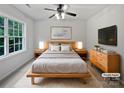 Modern bedroom with a wooden bed frame and neutral color palette at 15923 Prescott Hill Ave, Charlotte, NC 28277