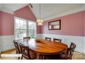 This pink dining room showcases an elegant chandelier and lots of natural light at 1835 Montague Rd, Clover, SC 29710