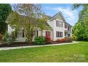 Charming two-story home featuring red shutters and a beautifully landscaped front yard at 305 Phillip Dr, Salisbury, NC 28146