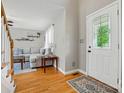Bright living room featuring hardwood floors, a white door with a decorative window, and comfortable seating at 305 Phillip Dr, Salisbury, NC 28146