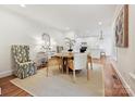 Inviting dining area featuring hardwood floors and stylish furnishings, with a view into the kitchen at 3610 Mill Pond Rd, Charlotte, NC 28226