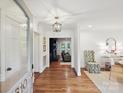 Bright foyer showcasing hardwood floors, elegant lighting, and seamless flow to the living spaces at 3610 Mill Pond Rd, Charlotte, NC 28226