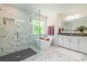 Bright bathroom with a luxurious soaking tub, separate glass shower, and elegant marble tile at 424 Preston Rd, Mooresville, NC 28117