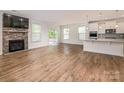 Sunlit living space flows into the modern kitchen with stone fireplace at 424 Preston Rd, Mooresville, NC 28117