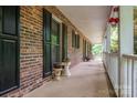 Spacious covered porch with ample room for seating and decor, ideal for enjoying the outdoor scenery at 480 S Ingleside Farm Rd, Iron Station, NC 28080
