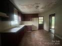 Functional kitchen with tile flooring, ample cabinet space, and a convenient back door at 4817 Ridgeley Dr, Charlotte, NC 28208