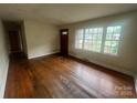 Spacious living room featuring hardwood floors, bright windows, and ample natural light at 4817 Ridgeley Dr, Charlotte, NC 28208