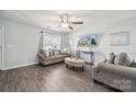 Bright living room with hardwood floors, large window, and cozy seating arrangement, creating a relaxing atmosphere at 509 Ellingsworth Ln, Charlotte, NC 28214
