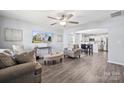 Inviting living room with hardwood floors, a ceiling fan, and comfortable seating next to an open kitchen at 509 Ellingsworth Ln, Charlotte, NC 28214