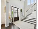 Bright, two story foyer featuring wood floors, high ceilings, and staircase at 5420 Meadowcroft Way, Fort Mill, SC 29708