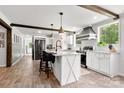 Modern kitchen features white cabinetry, stainless appliances, and wood-look flooring at 5528 Little Mountain Rd, Gastonia, NC 28056