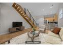 Inviting living room showcases hardwood floors, open staircase, and contemporary decor at 625 N Alexander St, Charlotte, NC 28202
