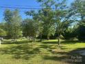 Spacious backyard with mature trees, offering plenty of room for outdoor activities at 6585 White St, Kershaw, SC 29067