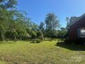 Lush backyard with a mix of lawn, trees, and garden beds perfect for gardening or relaxing at 6585 White St, Kershaw, SC 29067