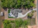 Overhead view of lakefront home and dock with a sprawling driveway and lush landscaping at 8044 Edgewater Dr # 100, Norwood, NC 28128