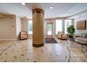 Welcoming lobby showcases a central mosaic column, comfortable seating, and convenient access to building exits at 1000 E Woodlawn Rd # 402, Charlotte, NC 28209
