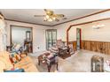 Warm living room with vintage details, including a ceiling fan, display cabinet, and cozy furniture at 1009 N Main St, Mount Holly, NC 28120