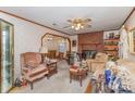 Cozy living room featuring a classic brick fireplace, ceiling fan, and comfortable seating area at 1009 N Main St, Mount Holly, NC 28120