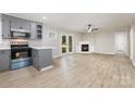 Open-concept living space boasts wood floors, a cozy fireplace, and double doors leading to the outdoors at 1141 Carolina Cir, Statesville, NC 28677