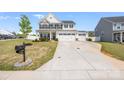 Traditional two-story home with a three-car garage and a long driveway at 1636 Tundra Ln, Denver, NC 28037