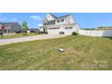 Beautiful exterior view of a well-maintained two-story home with a spacious green lawn at 1636 Tundra Ln, Denver, NC 28037