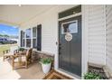 Inviting front porch with seating, a decorated door, and well-maintained landscaping, creating a welcoming entrance at 1636 Tundra Ln, Denver, NC 28037