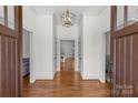 Inviting foyer with beautiful hardwood floors, statement lighting, and neutral walls creating a seamless flow throughout the home at 1655 Buckland Ct, Indian Land, SC 29707